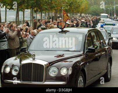 (dpa) - Her Majesty the Queen and her husband Prince Philip of Edinburgh are escorted by police as they drive past past flag waving fans in their Bentley along the Rhine river in Duesseldorf, Germany, 4 November 2004. After visits to the German states of Berlin and Brandenburg the Queen and Prince Philip have arrived in North Rhine Westphalia. Among the scheduled stops will be the  Stock Photo