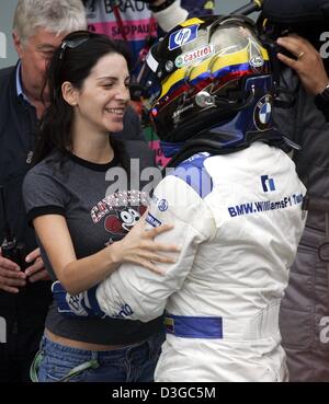 (dpa) - Colombian BMW pilot Juan Pablo Montoya (R) with his wife Connie after winning the Brazilian GP Formula One at the Interlagos circuit in Sao Paulo, 24 October 2004. Montoya finished first. Stock Photo