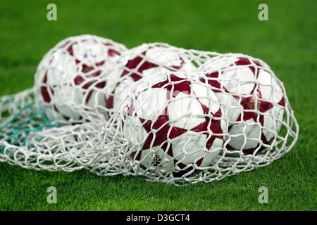 (dpa) - New official UEFA Champions League balls from adidas lie in a net next to the pitch during the Champions League match between Bayern Munich and Ajax Amsterdam at Olympic Stadium in Munich, Germany, 28 September 2004. The new 'Finale' offers major improvements over older balls such as the Power Balance Technology with features such as a superior PU surface plus highly resili Stock Photo