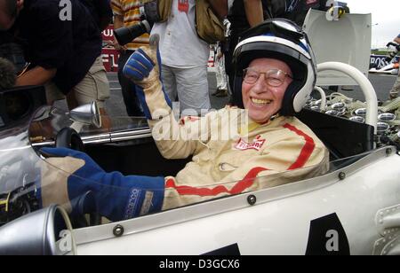 (dpa) - Briton John Surtees, former formula one world champion, laughs with his thumb up in the cockpit of his 1965 Honda in Suzuka, Japan, 10 October 2004. Surtees, who was born on 11 February 1934, started in a veteran's race during the supporting programme of the Grand Prix in Suzuka. He is the oldest formula one world champion who is still alive. Stock Photo