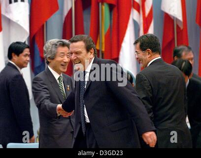 (dpa) - German Chancellor Gerhard Schroeder greets Japanese Prime Minister Junichiro Koizumi with a handshake ahead of the first working session at the 5th Asia Europe Meeting (ASEM 5) in Hanoi, Vietnam, 8 October 2004. The two-day summit is intended to increase cooperation and dialogue between Europe and Asia, but has been overshadowed by the row over Myanmar's admission. Stock Photo