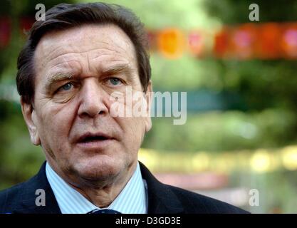 (dpa) - German Chancellor Gerhard Schroeder comments on the new bomb attempts in the Afghan capital Kabul on the sidelines of the 5th Asia Europe Meeting (ASEM 5) in Hanoi, Vietnam, Friday, 8 October 2004. German Chancellor Gerhard Schroeder said Friday he plans to stick with his plans to travel to Afghanistan, despite a rocket explosion just a few metres from the German embassy in Stock Photo