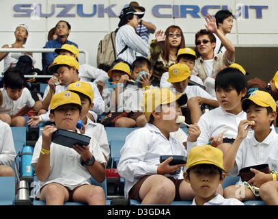 (dpa) - The school kids seem to be more interested in their lunch boxes than in what's going on in the pit lane during their excursion to the racing circuit in Suzuka, Japan, 7 October 2004. The Japanese formula one Grand Prix will be underway on Sunday, 10 October 2004. Stock Photo