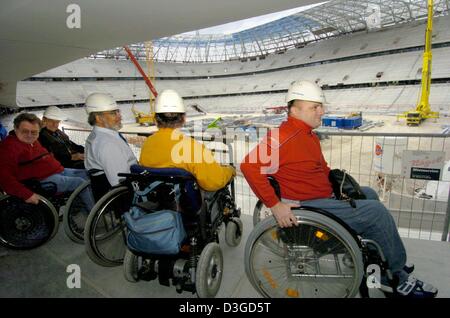 (dpa) - Wheelchair bound men from the Bayern Munich soccer team wheelchair fan club get a first glimpse of the view they will have from their seating area at the new Allianz Arena in Munich, Germany, 22 September 2004. According to representatives of disabled organizations and architects the new stadium will set new standards for the integration of disabled fans at sporting venues. Stock Photo