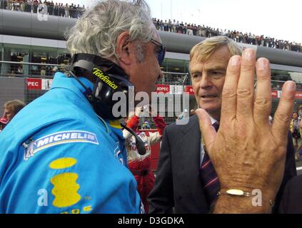 (dpa) - Renault team leader Flavio Briatore (L) gestures while talking to FIA boss Max Mosley (R) during the Chinese Grand Prix at the new Shanghai International Circuit in Shanghai, China, 26 September 2004. Stock Photo