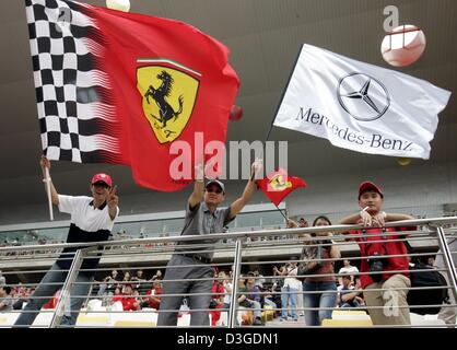 (dpa) - Chinese fans happily wave flags of their favourite Formula One teams at the new Shanghai International Circuit in Shanghai, China, Friday 24 September 2004. The Chinese Grand Prix, the first ever Formula One race on Chinese soil, will take place on Sunday, 26 September 2004. Stock Photo