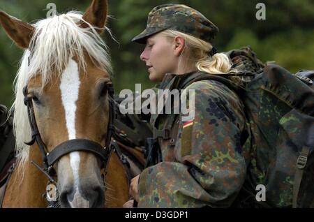 (dpa) - Private Maria Heinze stands next to her horse 'Nados' during the mountain infantry training 'Flinke Gams' in the Bavarian Alps near Mittenwald, Germany, 15 September 2004. 2000 international soldiers took part in the high mountain training. Stock Photo