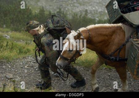 (dpa) - Private Maria Heinze leads her horse 'Nados' during the mountain infantry training 'Flinke Gams' in the Bavarian Alps near Mittenwald, Germany, 15 September 2004. 2000 international soldiers took part in the high mountain training. Stock Photo