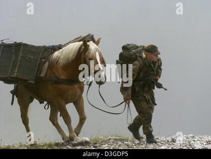 (dpa) - Private Maria Heinze leads her horse 'Nados' during the mountain infantry training 'Flinke Gams' in the Bavarian Alps near Mittenwald, Germany, 15 September 2004. 2000 international soldiers took part in the high mountain training. Stock Photo