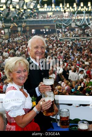 (dpa) - Bavarian Prime Minister Edmund Stoiber and his wife Karin clink their glasses during the opening of the Oktober Fest in Munich, 18 September 2004. Six million people are expected to visit the Munich Oktoberfest, which is one of the world's biggest and most famous festivals. The beer fest runs until 3 October. Stock Photo