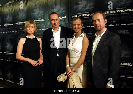 (dpa) - From L: Actress Corinna Harfouch, film producer Bernd Eichinger, his daughter Nina Eichinger and actor Ulrich Noethen pose in front of the posters for their film 'The Downfall: Hitler and the End of the Third Reich' which premiered in Munich, 9 September 2004. The film, which deals with the last days in the life of Adolf Hitler, celebrated its world premiere and is going to Stock Photo