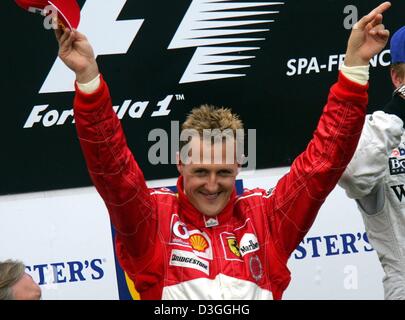 (dpa) - German Ferrari Formula One driver Michael Schumacher celebrates on the podium after the Belgian Formula One Grand Prix in Spa, 29 August 2004. Michael Schumacher finished in second place in the Grand Prix, clinching an unprecedented seventh world championship title despite not winning for just the second time in 14 races this season. Stock Photo