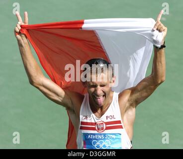 (dpa) Robert Korzeniowski from Poland jubilates after crossing the finish line of the men's 50 km walk in the Olympic stadium at the Athens 2004 Olympic Games. Stock Photo