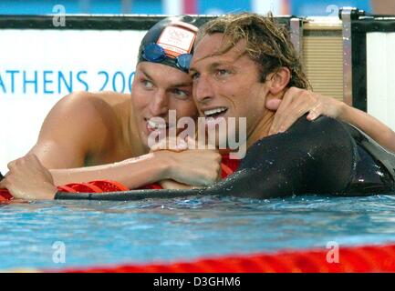 (dpa) - (from L:) Dutch Pieter van den Hoogenband congratulates Australian swimmer Ian Thorpe after he won the men's 200m freestyle final at the Olympic Aquatic Centre in Athens, Monday 16 August 2004. US Michael Phelps became third. Stock Photo