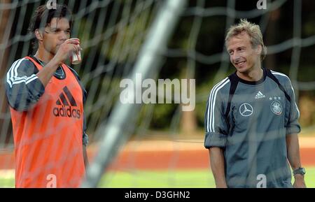 (dpa) - New German national soccer team coach Juergen Klinsmann (R) chats with midfielder Michael Ballack during a training session of the German national soccer team in Frankfurt Main, Germany, 16 August 2004. The German national team prepares for the friendly against Austria  on Wednesday August 18. Ballack is the newly appointed team captain replacing goalkeeper Oliver Kahn. Stock Photo