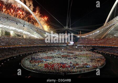 (dpa) - Olympic athletes gather in the Olympic Stadium during the fireworks at the opening ceremony of the 2004 Olympics in Athens, Friday 13 August 2004. Stock Photo