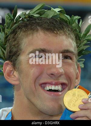 (dpa) - US swimmer Michael Phelps with the gold medal he won in the men's 400m individual medley setting a new world record at the Olympic Aquatic Centre in Athens, Saturday 14 August 2004. Stock Photo