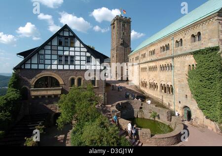 (dpa) - A view of Wartburg Castle located above the town of Eisenach, Germany, 3 August 2004. Although it has retained some original sections from the feudal period, it acquired its form during the 19th century reconstitution. It was during his exile at Wartburg Castle that Martin Luther translated the New Testament into German. In 1999 the Wartburg was added to the Unesco World He Stock Photo