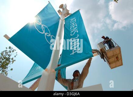 (dpa) - Builders adjust flags which display this year's Olympic logo at the OAKA Olympic Complex in Athens, Greece, 10 August 2004.  The 2004 Olympics will be launched with the Opening Ceremony on 13 August. Stock Photo