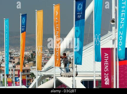 (dpa) - A builder affixes a row of flags inn front of the Olympic Stadium in Athens, Greece, 09 August 2004. The 2004 Olympics will be launched with the Opening Ceremony on 13 August. Stock Photo