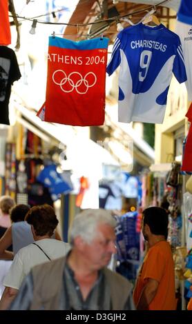 (dpa) - An Olympic flag and the jersey of Greek national team soccer player Charisteas hang above a street in the old town of Athens called Plaka in Greece, Thursday, 05 August 2004. Many shops already started to sell Olympic souvenirs. The Olympic Games will commence with an opening ceremony in Athens as of 13 August 2004. Stock Photo