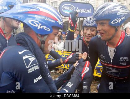 (dpa) - US cyclist Lance Armstrong (L) of team US Postal Services and his teammates Jose Luis Rubiera (C) from Spain and Pavel Padrnos from Czechia cheer after winning the team time trial race at the fourth stage of the Tour de France leading from Cambrai to Arras, France, 7 July 2004. Even torrential rain during the team time trial race from Cambrai to Arras could not stop the 32- Stock Photo