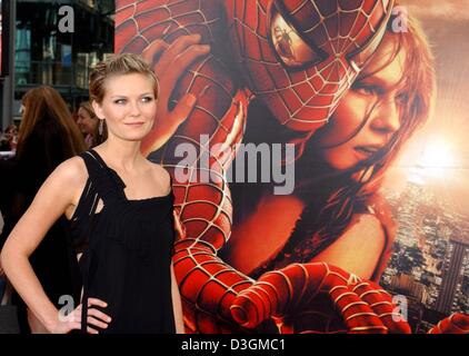 (dpa) - US actress Kirsten Dunst poses for the photographers at the European premiere of 'Spider Man 2' in which she plays a leading role, in Berlin, Germany, 6 July 2004. The plot centres around photographer Peter Parker who wants to rid himself of his alter ego 'Spider Man' to live a normal life and have more time for his girlfriend MJ. The movie officially opens on 8 July 2004. Stock Photo