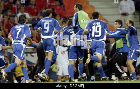 (dpa) - The players of the Greek national soccer team jump up, cheer and jubilate after the final whistle of the Soccer Euro 2004 semifinal opposing Greece and the Czech Republic  in Porto, Portugal, 1 July 2004. Greece won with a 1-0 silver goal during extra time in the 105th minute of the game and qualified for the Euro 2004 final playing against Portugal. +++ NO MOBILE PHONE APP Stock Photo