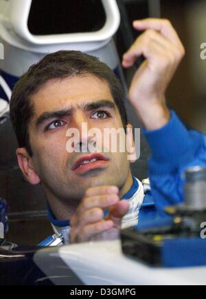 (dpa files) - Spanish formula one pilot Marc Gene, test driver at BMW-Williams, gets into his race car ahead of the free training in Monza, Italy, 13 September 2003. Gene will replace Germany's Ralf Schumacher in the upcoming Grand Prix of France at Magny-Cours, the BMW-Williams team said on 30 June 2004. Ralf Schumacher will not race in this weekend's French Grand Prix and may in  Stock Photo