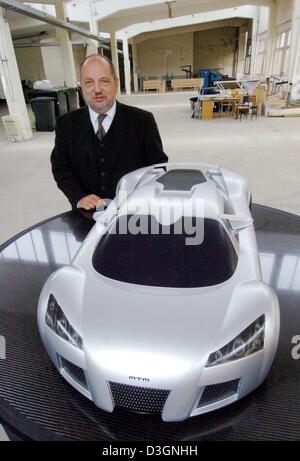 (dpa) - Rainer Willms, CEO of trading house 'Ossiversand.de', stands in the future assembly hall in front of a 1:4 scaled down model of the 'Apollo' sports car in Altenburg, Germany, 16 June 2004. The GMG Sportwagen-Manufaktur Altenburg (GMG sports car manufacturer) wants to start producing the car this year with the first five cars to be completed before year's end. Later about 50 Stock Photo