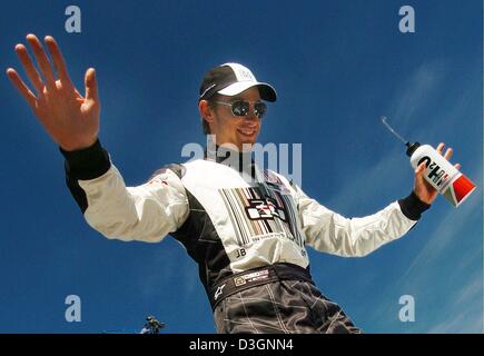 (dpa) - British formula one pilot Jenson Button (BAR Honda) raises his hands as he walks up the stairs during the drivers' parade ahead of the Grand Prix of Canada in Montreal, 13 June 2004. Stock Photo