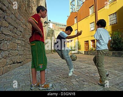 (dpa) - Three Portuguese youths play a round of soccer in a narrow alley in the old town of Porto, Portugal, 8 June 2004. The opening game of the 2004 European Soccer Championships is going to take place on Saturday 12 June 2004. Stock Photo