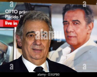 (dpa) - Spanish tenor Placido Domingo poses in front of the advertisement for his only concert in Germany this year, in Cologne, 6 March 2004. Stock Photo