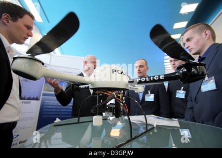 Participants learn about a micro drone of the type Typ MD 4-200 at the 16th European Police Congress in Berlin, Germany, 19 February 2013. The Congress with the motto 'Schutz und Sicherheit im digitalen Raum' ('Protection and safety in the digital space') focuses on the role of the police in social networks, ePolice and equipment and ends on 20 February 2013. Photo: Wolfgang Kumm Stock Photo