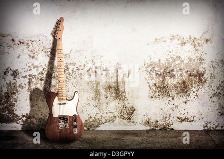 wood electric guitar with shadow on white grunge wall Stock Photo