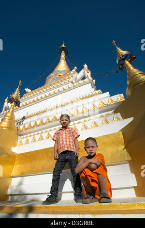 A Buddhist novice monk poses for the camera with his friend at Wat Mo Paeng in Pai valley, Mae Hong Son province, Thailand Stock Photo