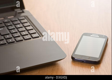 Laptop and mobile phone on an office desk. Stock Photo