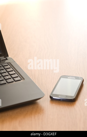 Laptop and mobile phone on an office desk. Stock Photo