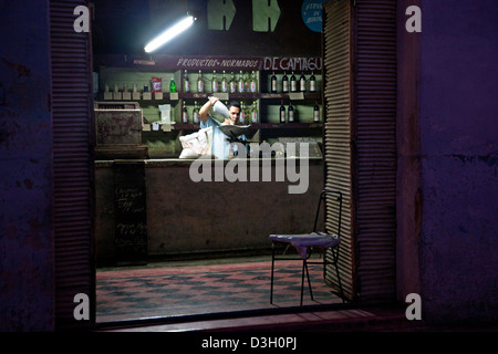 Shopkeeper behind counter of Cuban state shop in the city Camagüey, Cuba, Caribbean Stock Photo