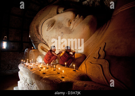 Two young monks meditating at The sleeping Buddha, Shwesandaw Paya Bagan Stock Photo