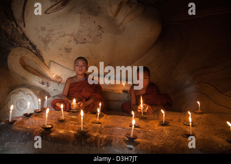 Two young monks meditating at The sleeping Buddha, Shwesandaw Paya Bagan Stock Photo