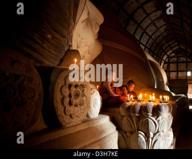 Two young monks meditating at The sleeping Buddha, Shwesandaw Paya Bagan Stock Photo