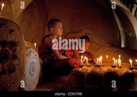 Two young monks meditating at The sleeping Buddha, Shwesandaw Paya Bagan Stock Photo