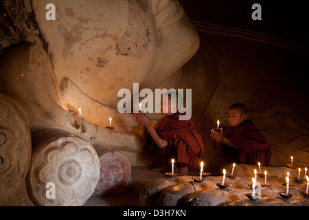 Two young monks meditating at The sleeping Buddha, Shwesandaw Paya Bagan Stock Photo