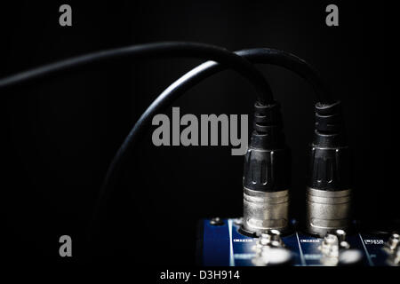 Color shot of many jacks plugged in a mixer Stock Photo