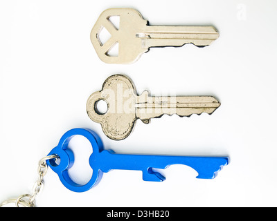 Couple keys and a blue stainless steel key's keychain isolated on white background Stock Photo