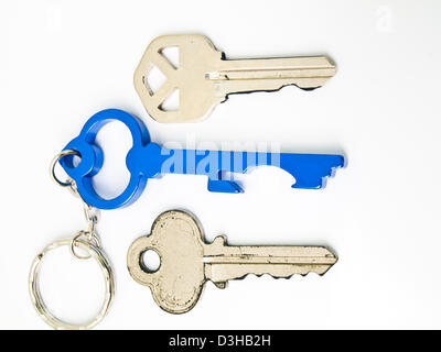 Couple keys and a blue stainless steel key's keychain isolated on white background Stock Photo