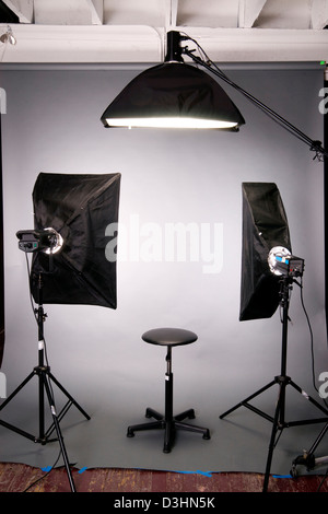 Two main lights a hair light posing stool on grey seamless in the studio Stock Photo