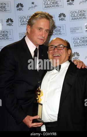 (dpa) - US actor Michael Douglas (L) embraces his colleague Danny DeVito while posing with the Cecil B DeMille Prize after the Golden Globe Awards in Beverly Hills, USA, 25 January 2004. Douglas received the award for his involvement in film and cinema. His father Kirk Douglas had received the same award in 1968. Stock Photo
