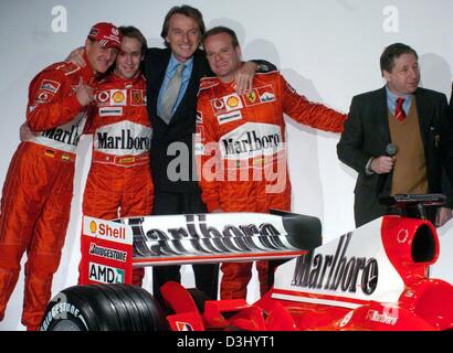 (dpa) - From L: German formula one pilot Michael Schumacher, test driver Luca Badoer, Ferrari President Luca di Montezemolo, Brazilian formula one driver Rubens Barrichello and Ferrari team captain Jean Todt pose after they unveiled the new Ferrari formula one car for the season 2004, in Maranello, Italy, 26 January 2004. The formula one season kicks off on 7 March in Australia. Stock Photo